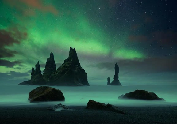 Reynisdrangar  en Islande, sous les aurores boréales